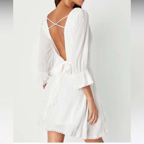 Embroidered white v neck sundress with open back and back bow tie detail - Picture 2 of 10